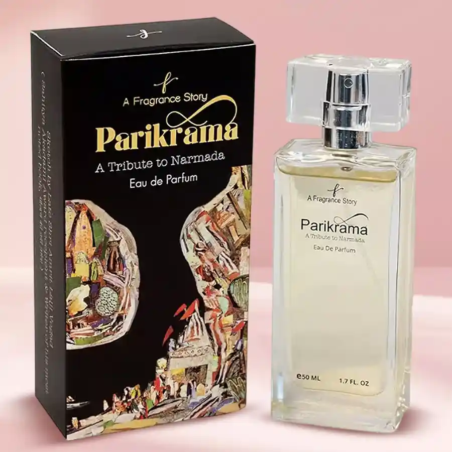 Bottle of Narmada Trail Parikrama Perfume surrounded by fresh mint, bergamot, water lilies, cedarwood, and musk elements, evoking a serene riverside atmosphere.