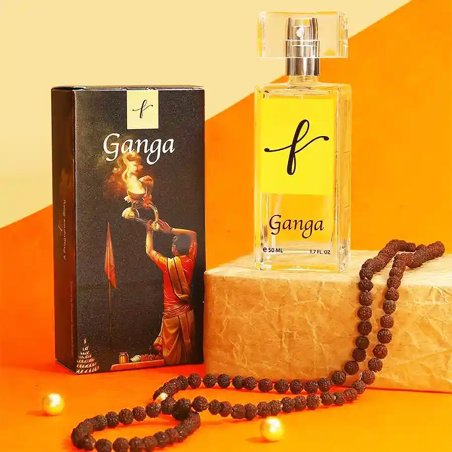 A serene bottle of Ganga Aarti Essence perfume surrounded by flickering diyas, capturing the essence of tranquility and spirituality.