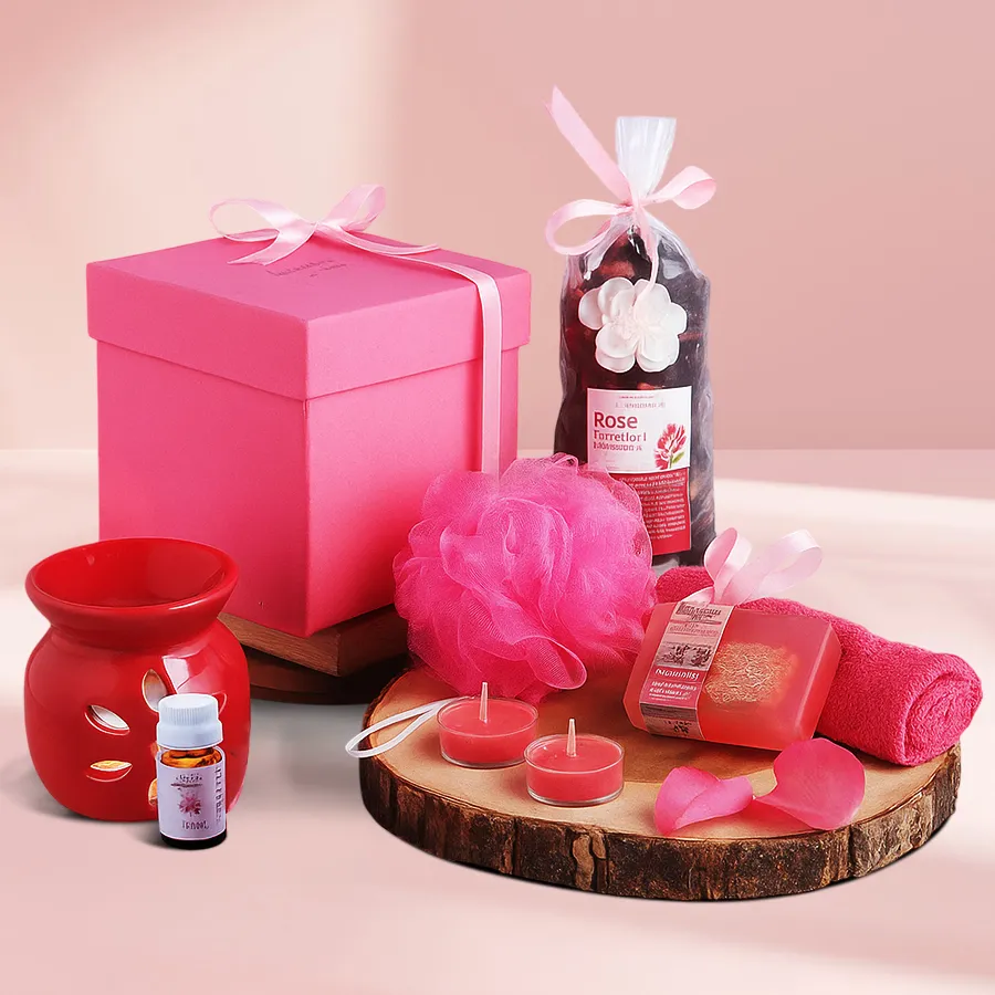 Enthralling Rose Soap Spa Gift Set with a cozy bathrobe, featuring a Rose Bathing Bar, Face Terry Towel, Aroma Diffuser, Rose Potpourri, Bath Puff, and Tea Lights arranged beautifully.