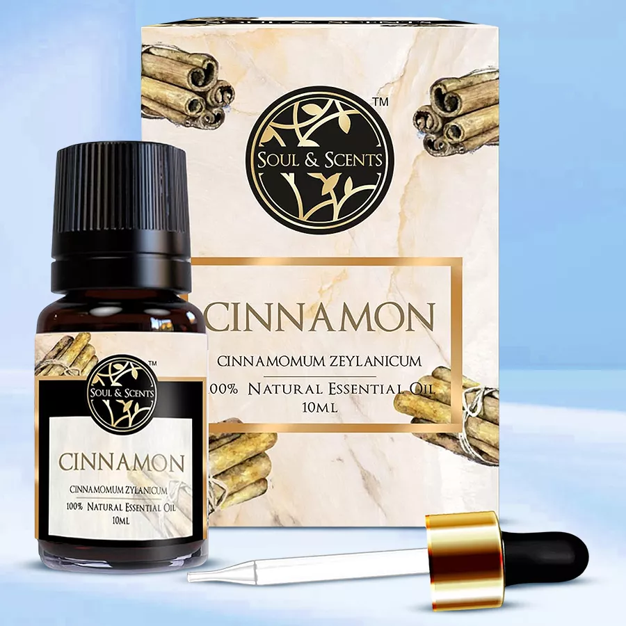 A 10ml bottle of Exotic Cinnamon Essential Oil surrounded by cinnamon sticks and greenery, conveying warmth and comfort.