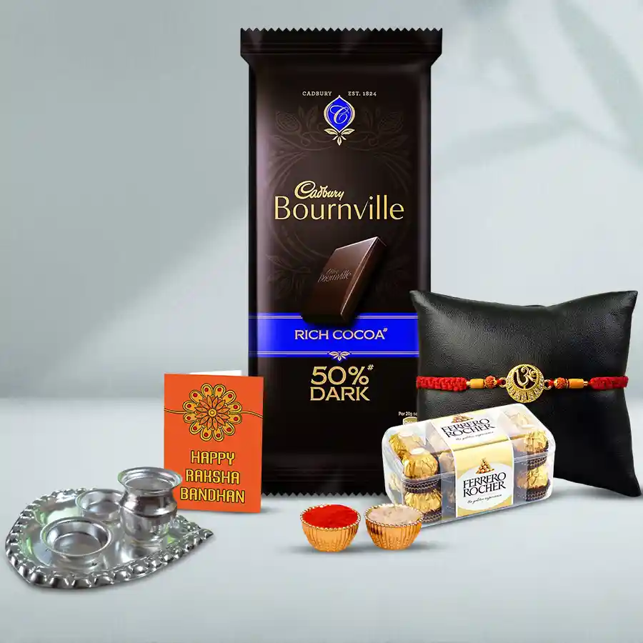 Holy Om Rakhi gift set featuring a silver-plated paan-shaped thali, Ferrero Rocher and Cadbury Bournville chocolates, roli tilak, chawal, and a personalized Rakhi card.