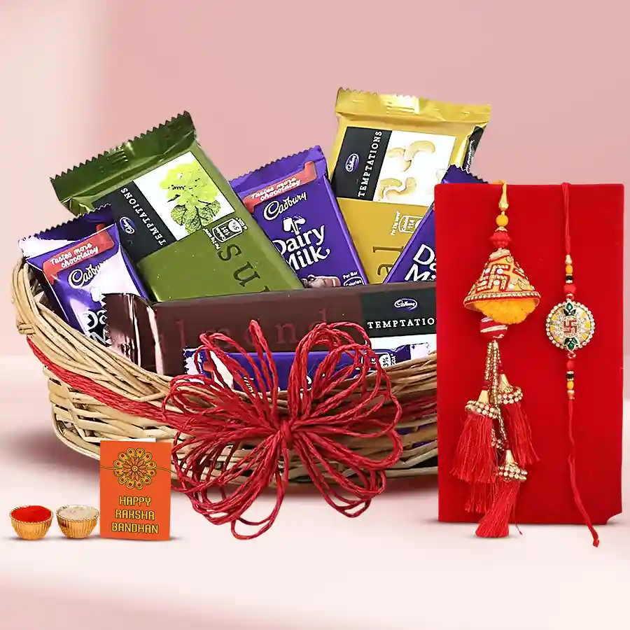 Basket filled with Cadbury Dairy Milk and Temptations chocolates, a beautiful rakhi set, a heartfelt card, traditional Roli, Tilak, and Chawal, all elegantly arranged in a charming cane basket for Raksha Bandhan celebration.