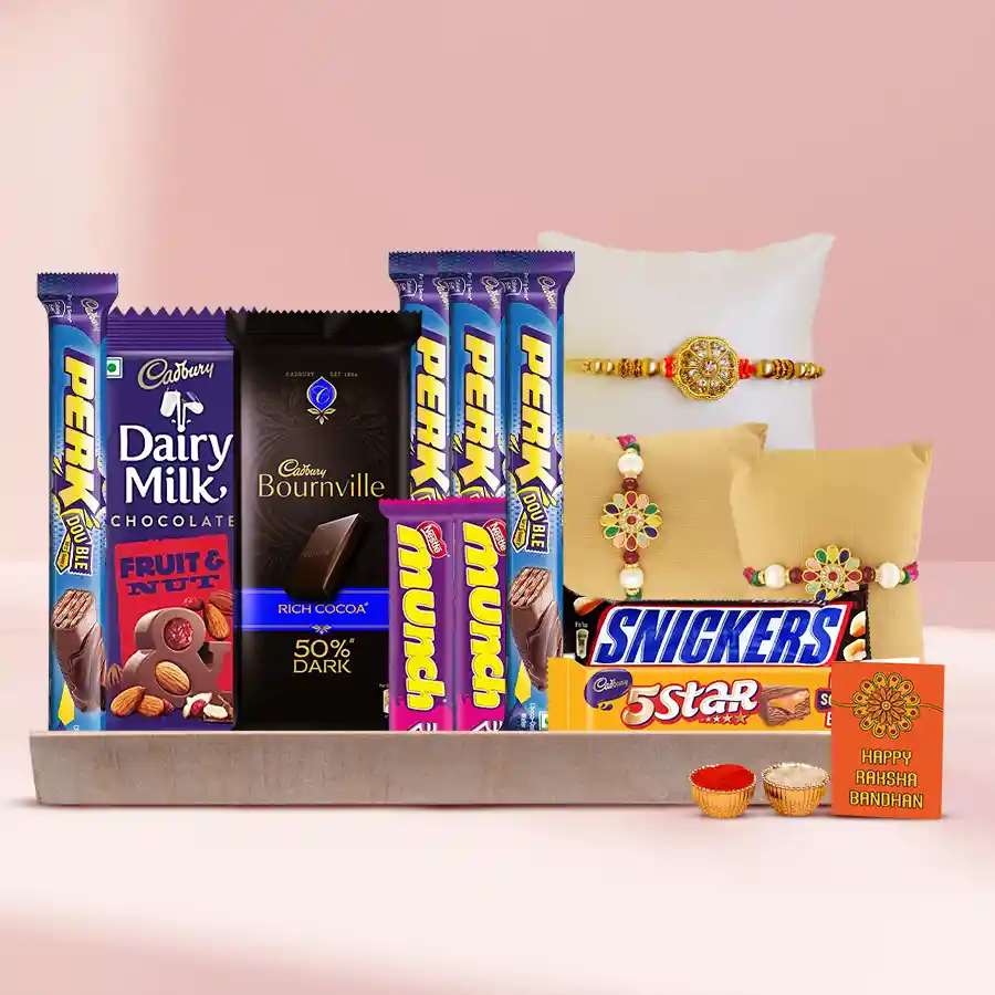 Stone Rakhis with assorted chocolates on a wooden tray, accompanied by Roli, Tilak, and Chawal.