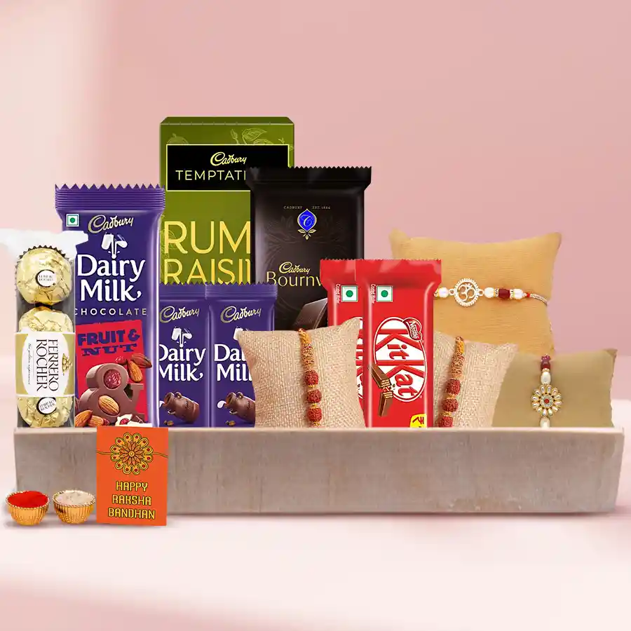 Chocolate N Rakhi Extravaganza gift box featuring Ferrero Rocher, Cadbury chocolates, Nestle Kit Kats, a traditional rakhi, roli, tilak, and chawal.