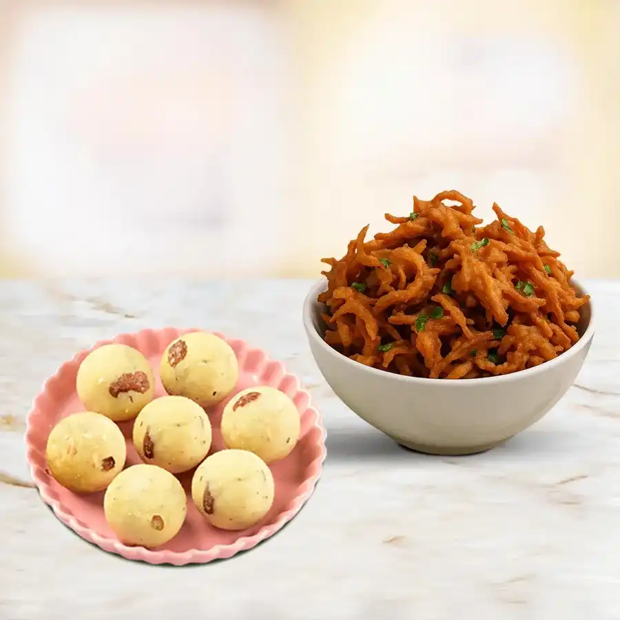 Treat box featuring Rawa Laddu and Onion Pakora for a sweet and savory experience.