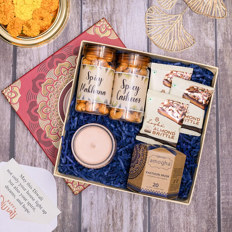 Spice N Serenity Treat Box featuring zesty spicy makhana, crunchy cashews, elegant Iris ribbed jar, Amogha incense cones, and Loyka almond brittle in a reusable gift box.