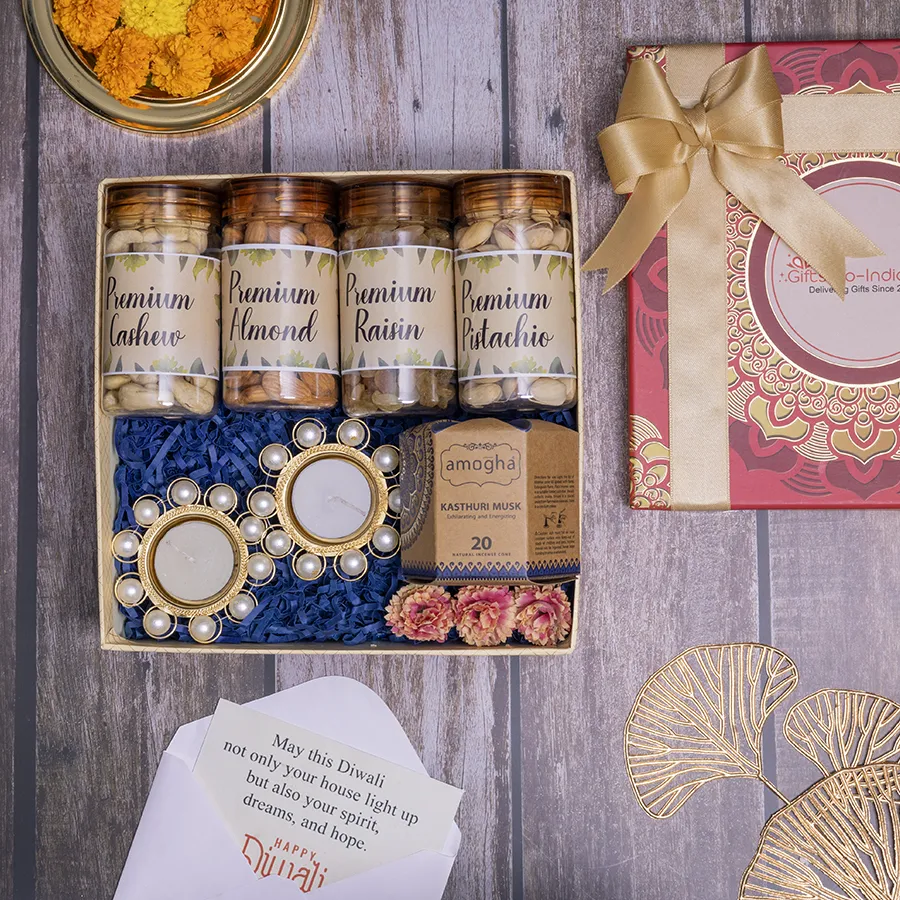 Premium Dry Fruits and Pearl Diya Set with jars of cashews, almonds, pistachios, raisins, Amogha incense cones, and elegant pearl diyas in a reusable gift box