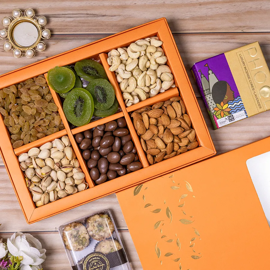 Delicious Diwali Treats Hamper with assorted nuts, baklava, a pearl diya, and incense cones in a reusable gift box.