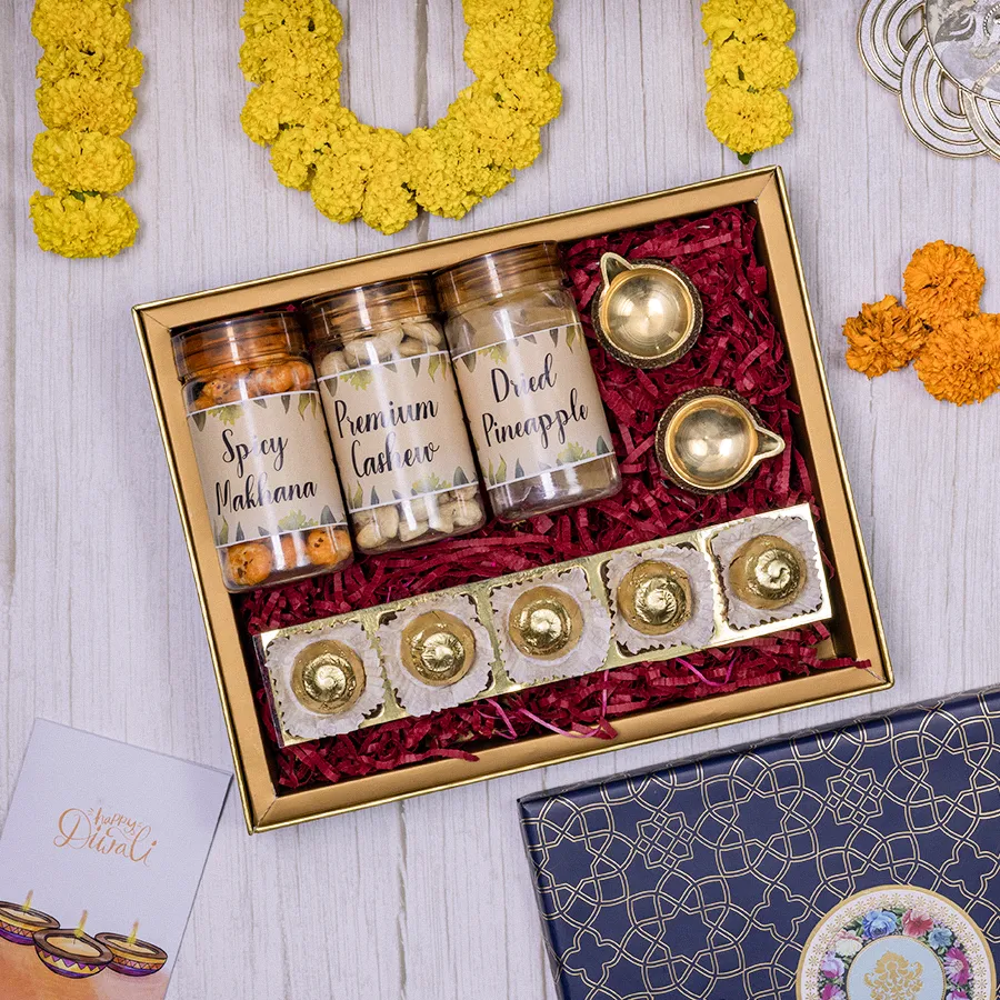 Diwali Delight Hamper with Spicy Makhana, premium Cashews, Dried Pineapple, homemade chocolates, Brass Diyas in a reusable gift box