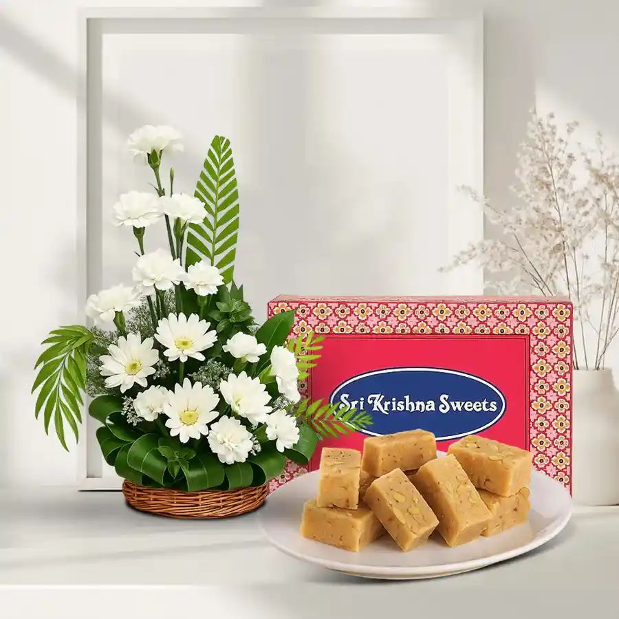 Elegant arrangement of white flowers with Mysore Pak gift set.