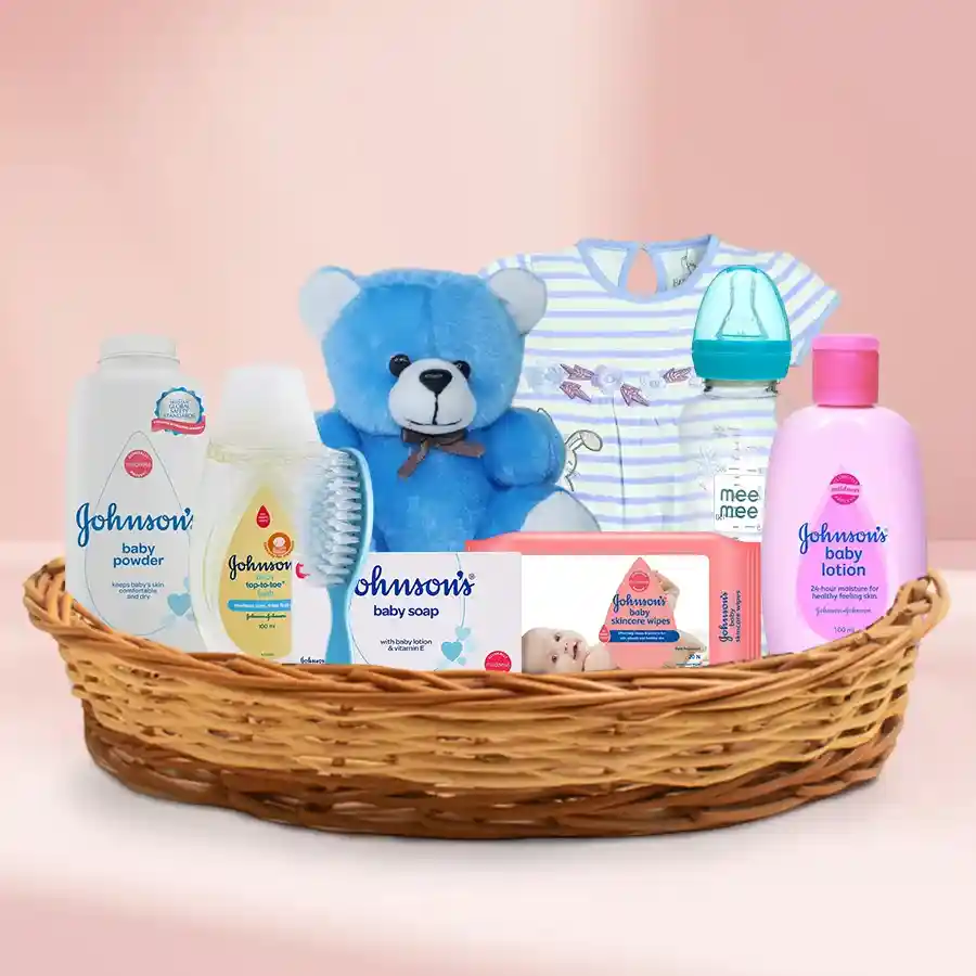 Joyful Babycare Gift Set Bundle featuring baby essentials, a teddy bear, and a dress, beautifully arranged in a reusable basket.