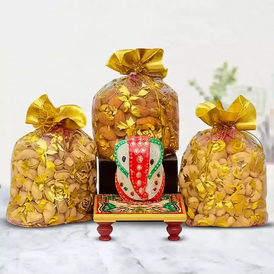 Exclusive Marble Ganesha idol with assorted dry fruits in decorative potlis.