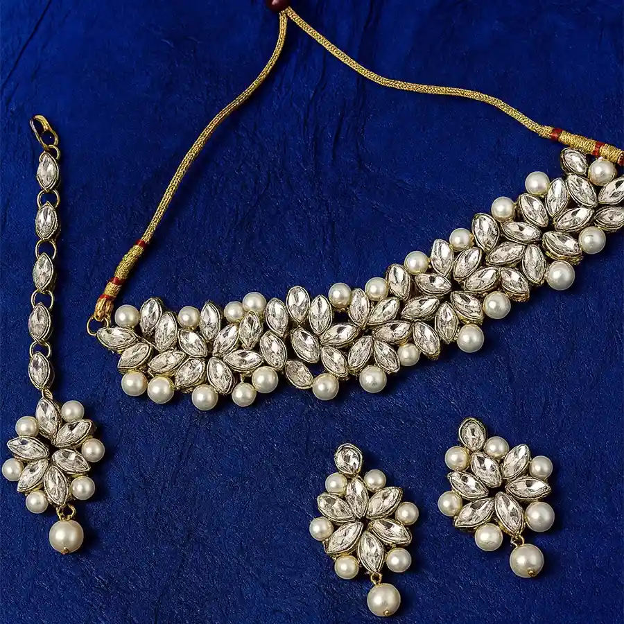 Regal Kundan Jewellery Ensemble featuring choker, earrings, and Maang Tika, showcasing intricate gemstone craftsmanship.
