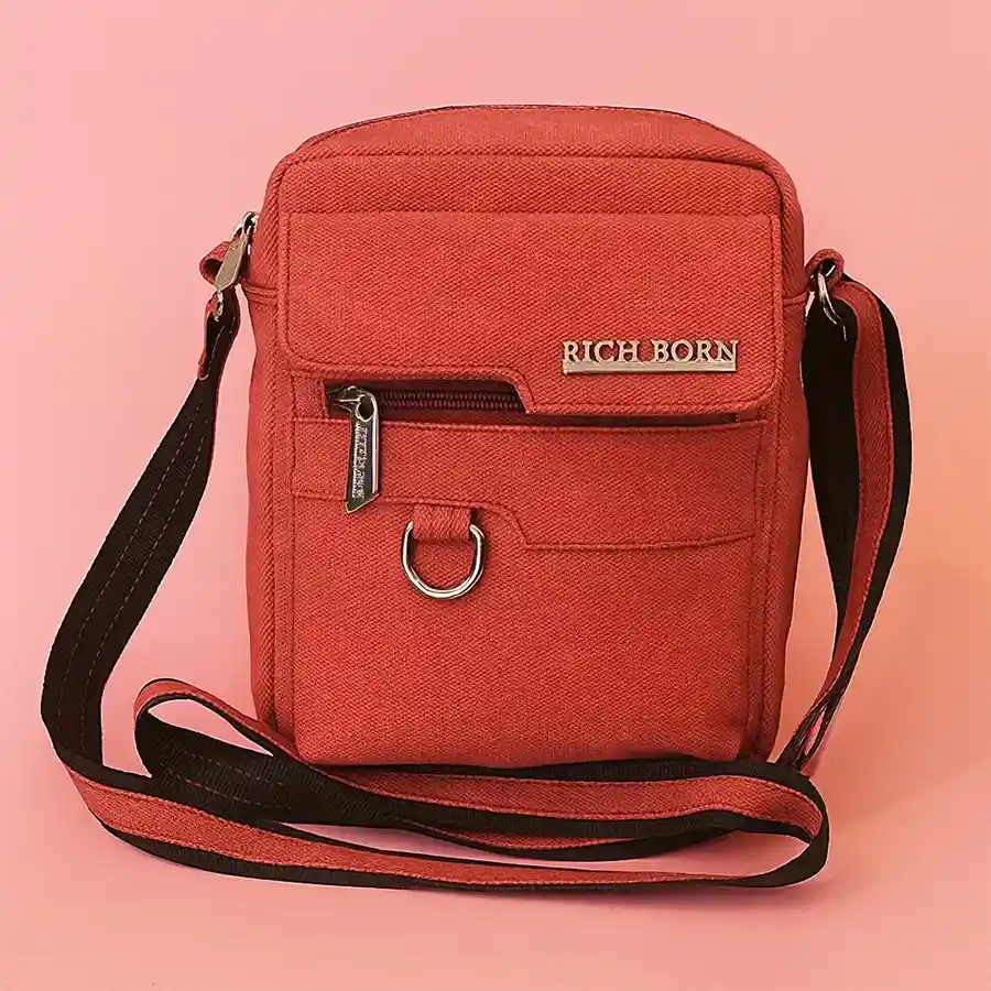 Cherry color sling bag for men with front pocket, made of foam leather, by Richborn.