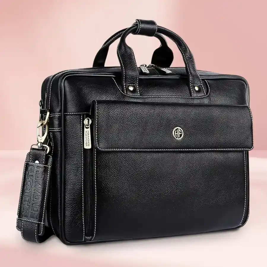 Stylish leather laptop bag for men in royal blue, designed for laptops up to 16 inches with an adjustable strap and expandable design.