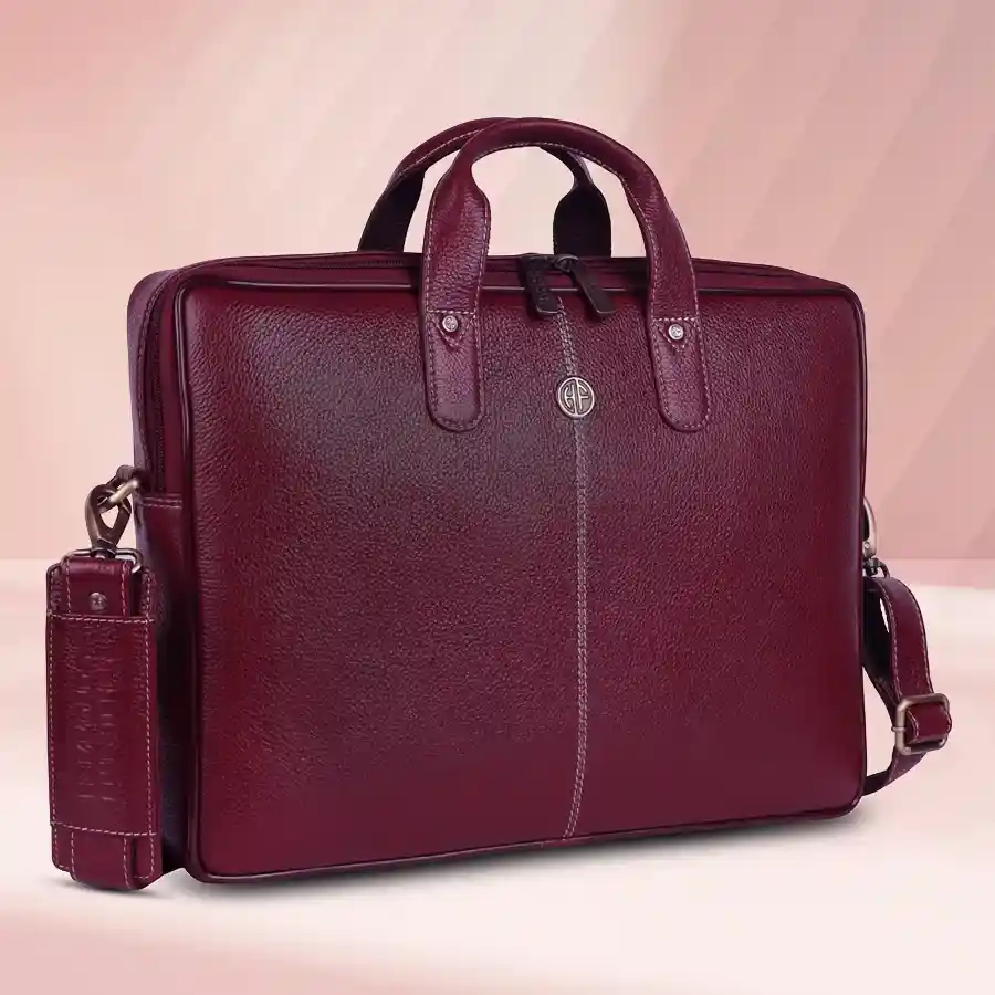 Stylish brown leather laptop bag for men, fits up to 14-inch laptops, perfect for office use with adjustable shoulder strap.