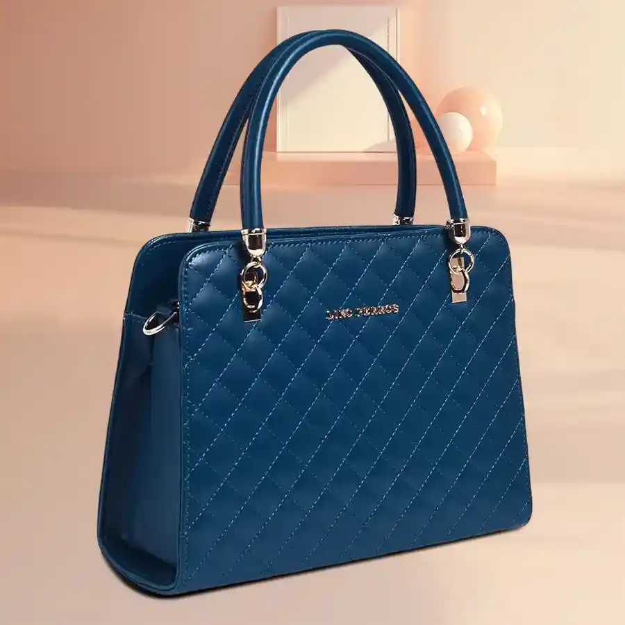 Chic cherry red leather handbag by Lino Perros, featuring a spacious compartment for essentials.