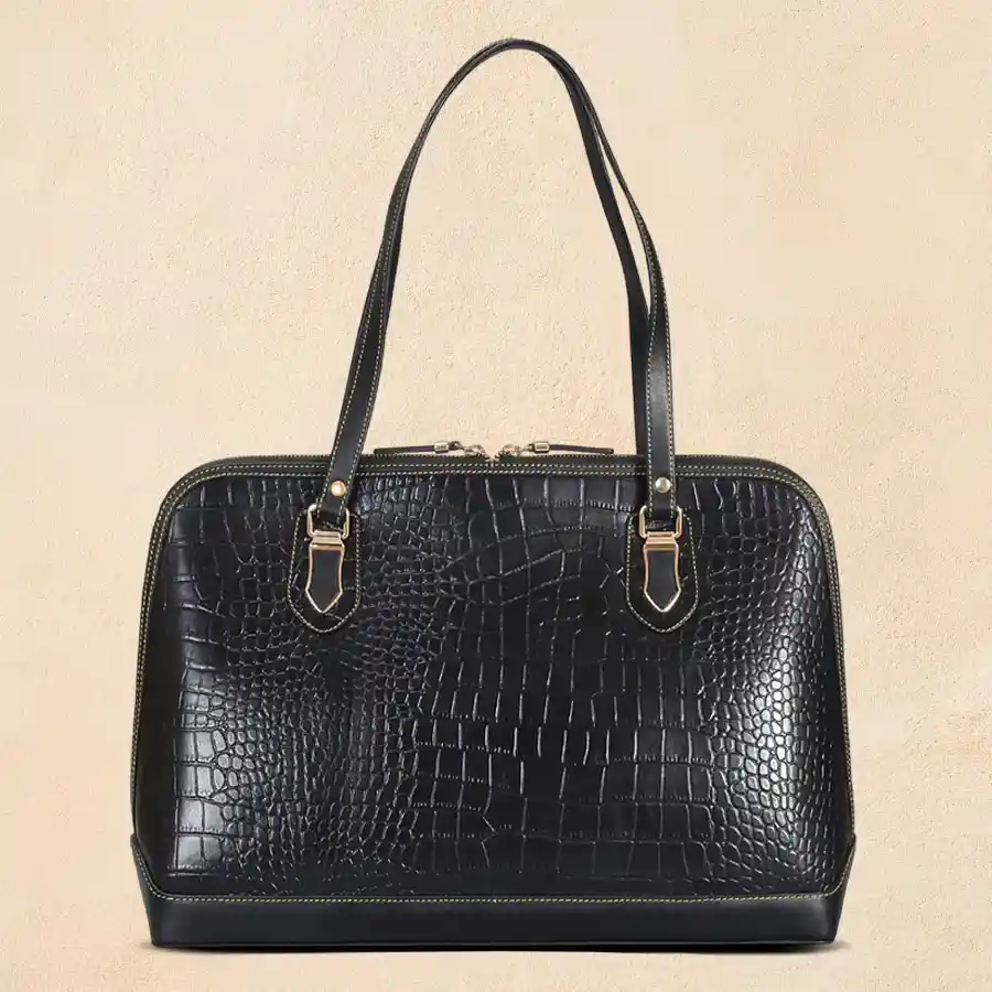 Chic black faux leather shoulder bag with front zip, perfect for versatile styling.