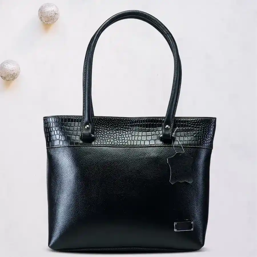 Stylish black faux leather vanity bag with a three-strip design, ideal for modern women.