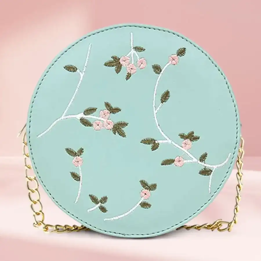 Chic green round embroidered sling bag with adjustable strap and zipper closure, perfect for daily use and stylish outings.