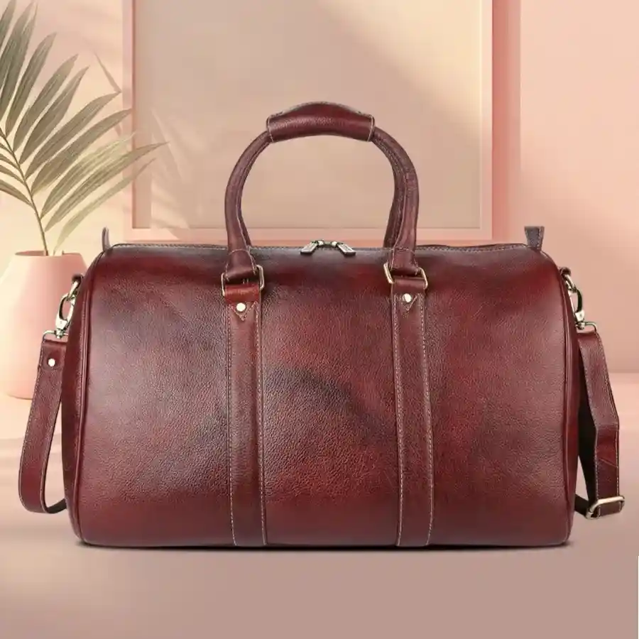 Luxurious 22-inch brown leather travel bag with spacious interior and detachable shoulder strap.
