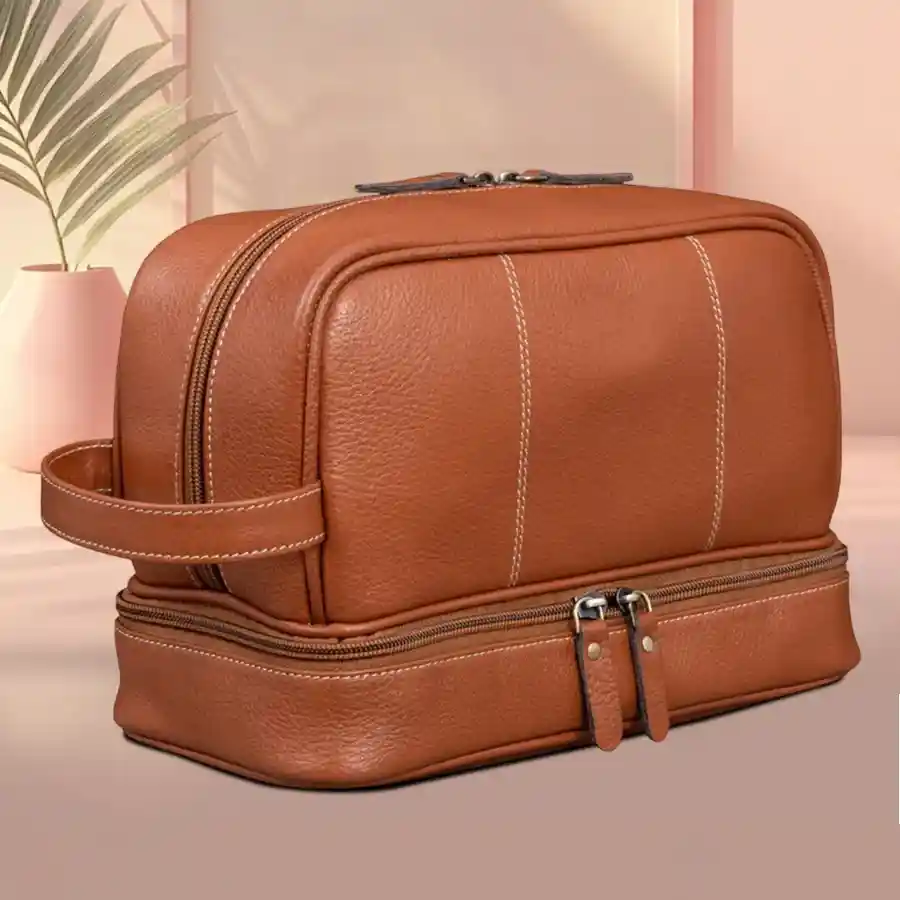 A stylish tan leather toiletry bag with compartments for travel essentials.