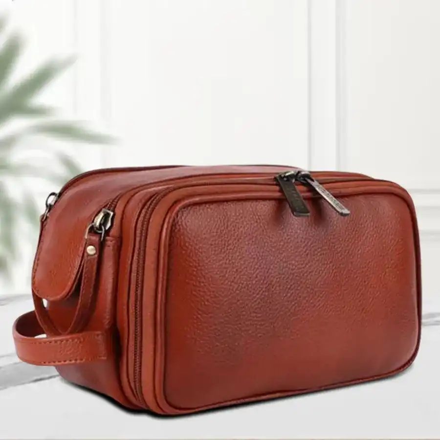 Tan Leather Toiletry Travel Kit with multiple compartments for organized grooming essentials.