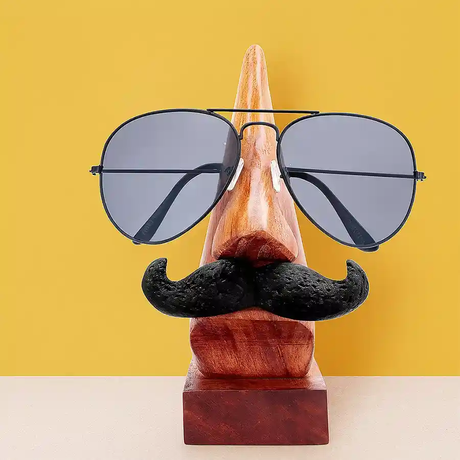 Unique handmade wooden nose-shaped spectacle stand with moustache, perfect for holding glasses and adding character to your desk.