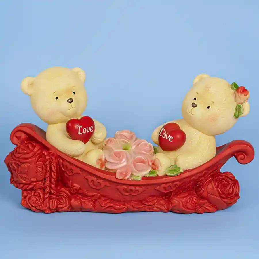 Love Nest Teddy showpiece with cuddly couple, hearts, and roses in a whimsical boat.