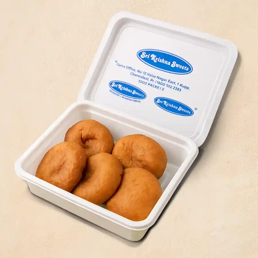 Badusha Delight: A traditional Indian sweet with flaky pastry and syrupy center, perfect for celebrations or heartfelt gifting.