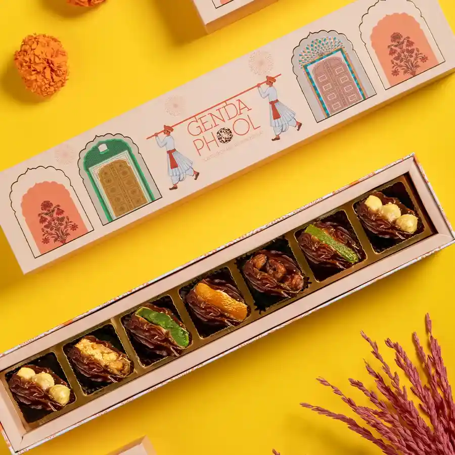 Elegant gift box containing 7 assorted stuffed Medjool dates topped with 24-carat gold varq.