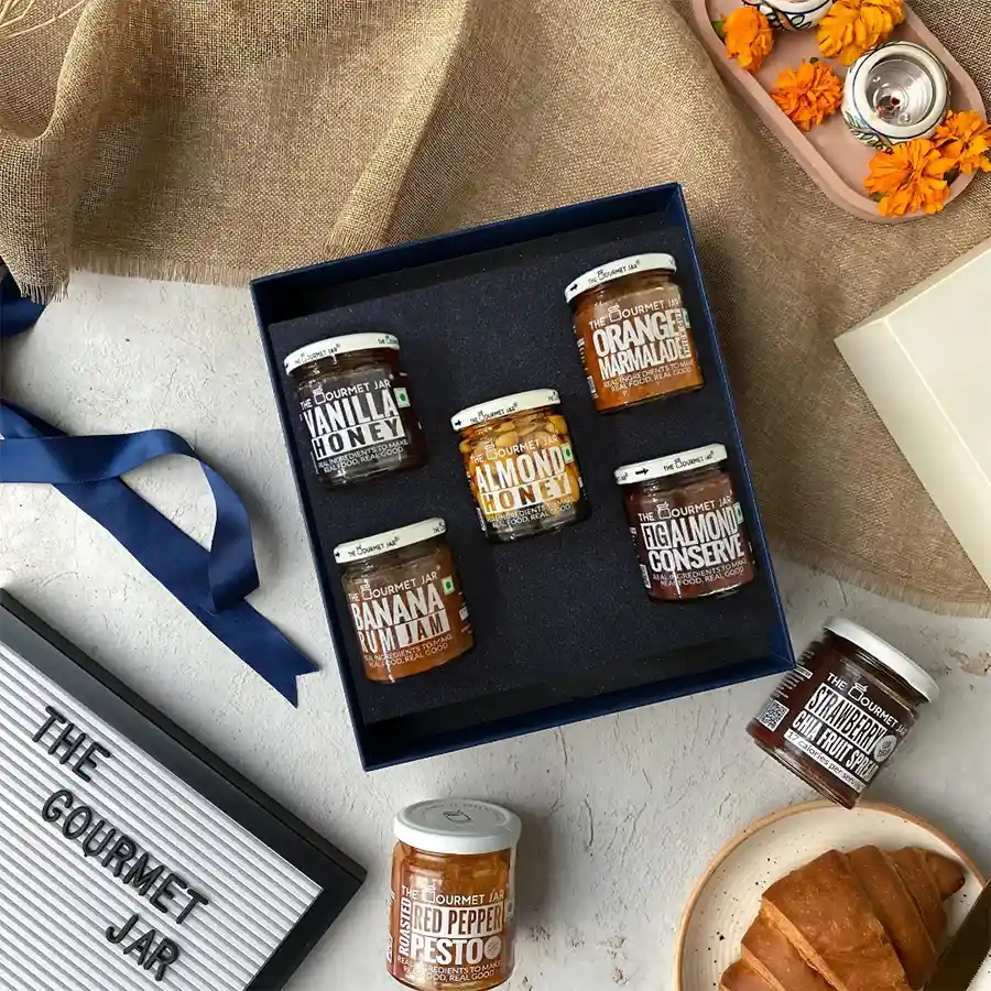 Gourmet Spreads Bliss Hamper featuring Almond Honey, Vanilla Honey, Banana Rum Jam, Fig Almond Conserve, and Thick Cut Orange Marmalade.