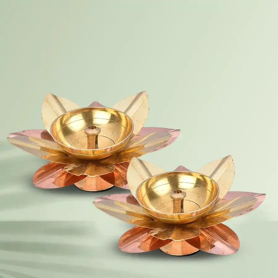 A set of two golden brass lamps in the shape of lotus flowers, ideal for spiritual rituals and home décor.