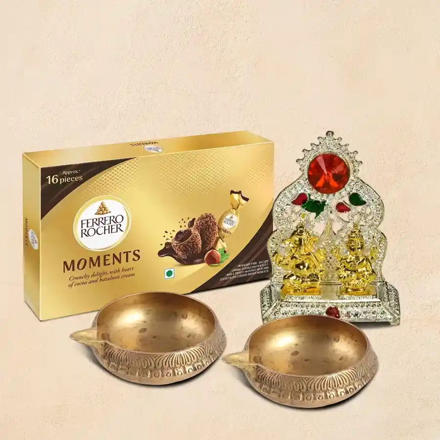 Divine Blessings Diya gift set featuring two gold-colored Diyas, Ferrero Rocher chocolates, and a brass Ganesh Laxmi Mandap.