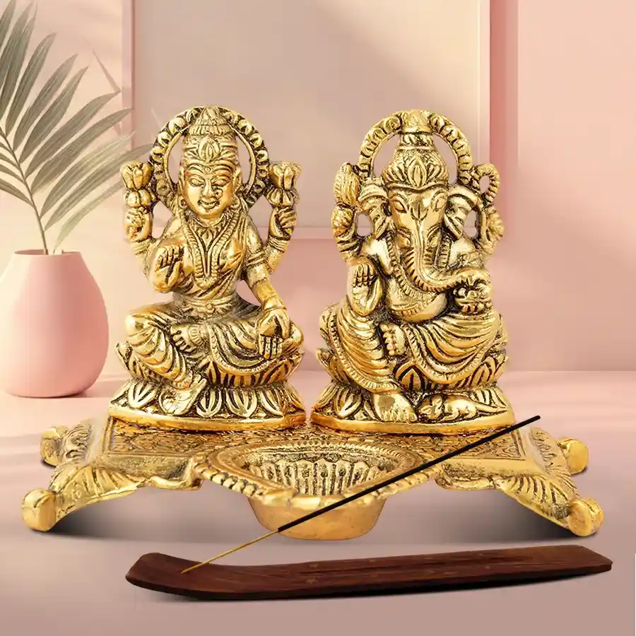 Beautiful Laxmi Ganesh idol showpiece with gold diya and wooden agarbatti stand for Diwali decoration.