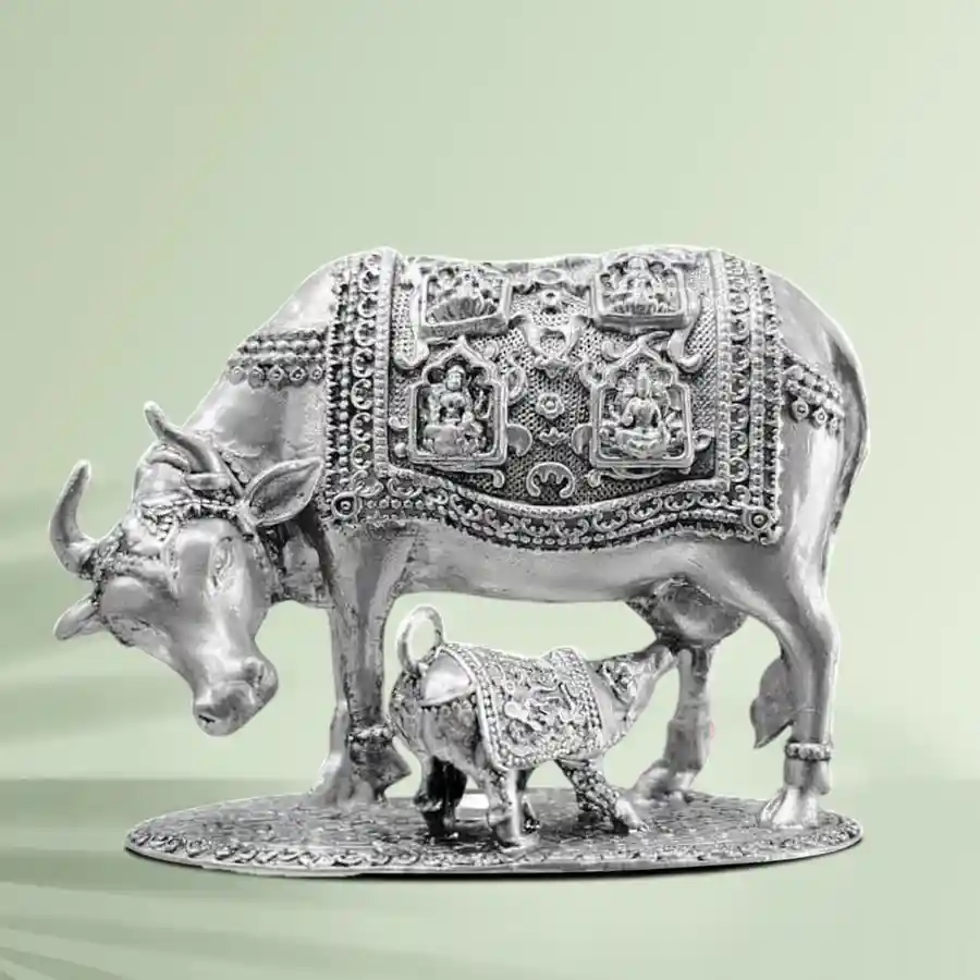 - Item: Metal Kamdhenu Cow and Calf Idol for Pooja Mandir- Material: Metal- Color: Silver Plated