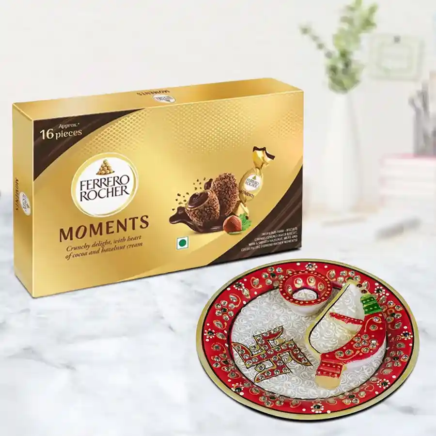 Festive marble Pooja Thali set with diya and Ferrero Rocher chocolates in a colorful arrangement.