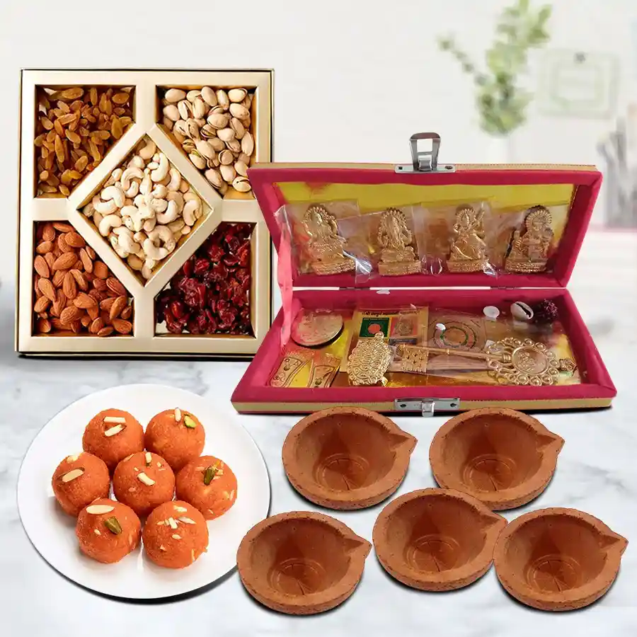 Auspicious Dhan Laxmi Kuber Yantra gift set with ladoos and dry fruits.