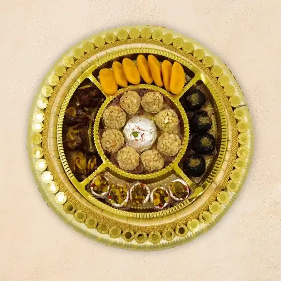 A beautifully arranged sweet platter featuring Kaju Choco Balls, Butter Scotch Balls, Kaju Katori, Khajur Laddoo, Sattoo Ladoo, and Kesaria Peda.