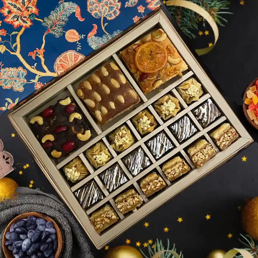 Holiday Bliss Treats Gift Set featuring a Christmas cake and baklava in festive packaging.