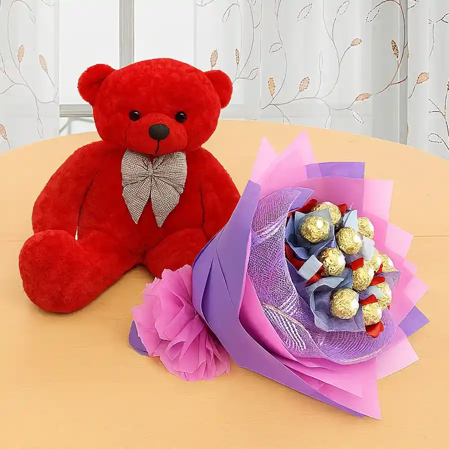 Enchanting 9-inch red teddy bear with a bouquet of 12 Ferrero Rocher chocolates.