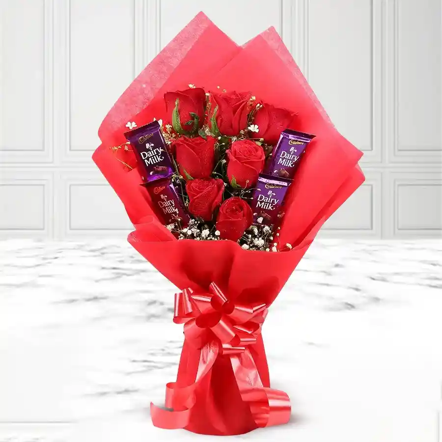 A bunch of 6 red roses paired with 6 Cadbury Dairy Milk chocolate bars, ideal for gifting.