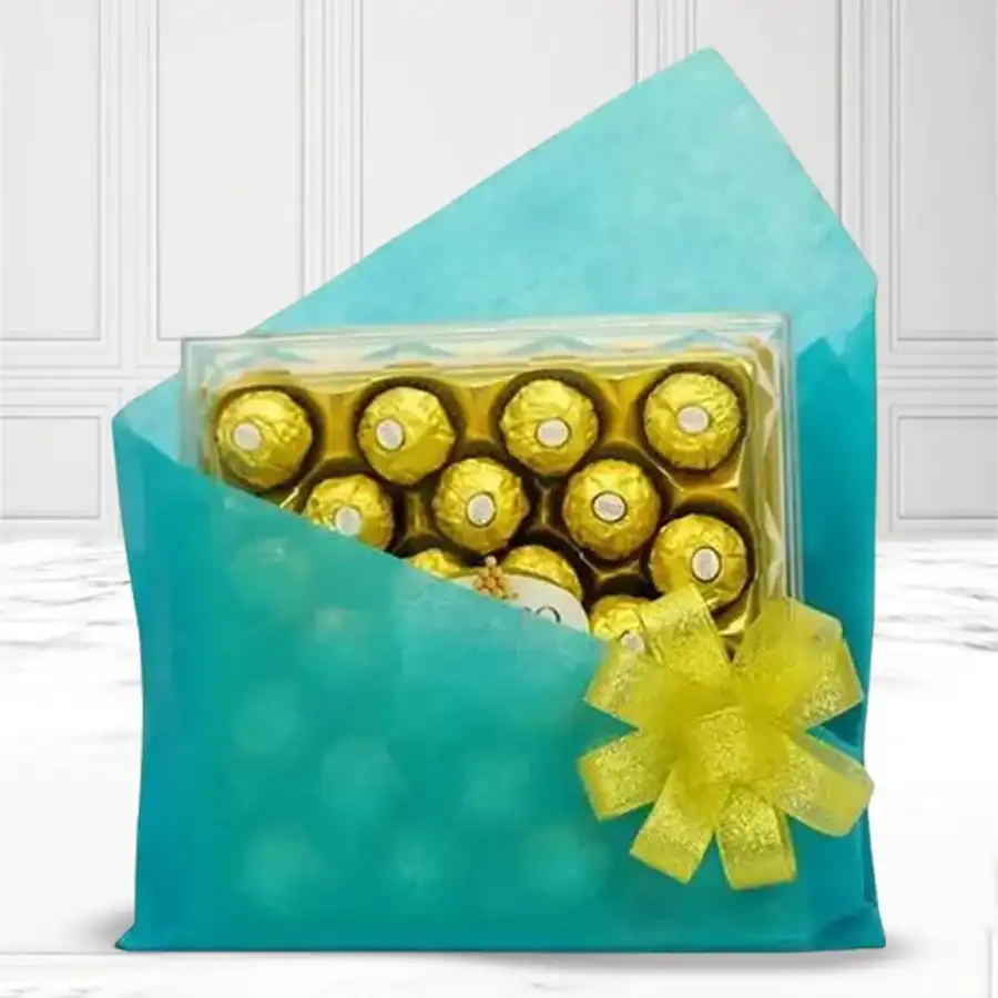 24-piece Ferrero Rocher chocolate box wrapped in blue tissue for gifting.