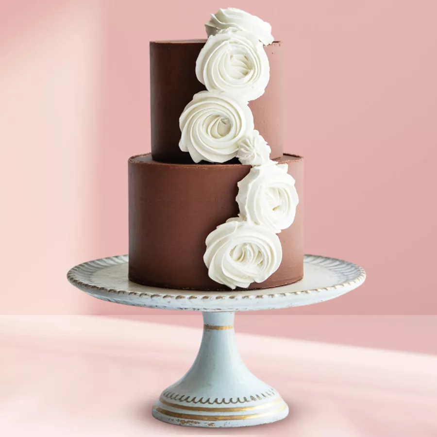 Two-tiered decadent chocolate fondant cake with floral toppings.
