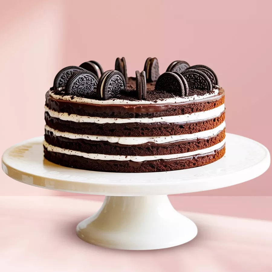 Oreo Chocolate Bliss Cake featuring a chocolate sponge base, white frosting, chocolate glaze, and topped with Oreo biscuits.