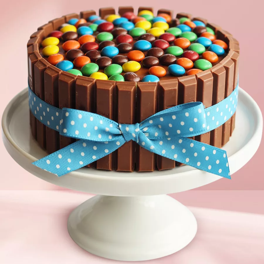 KitKat & Gems Chocolate Indulgence cake with rich frosting and colorful toppings.