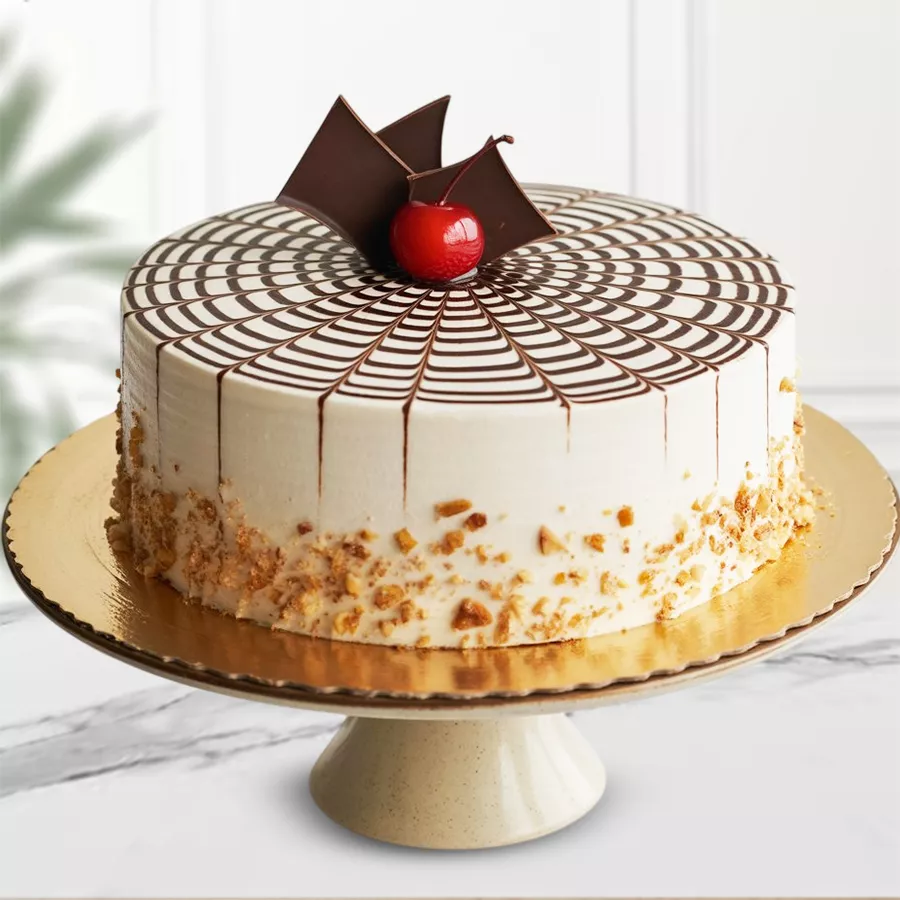 Butterscotch Bliss Cake with cream frosting, chocolate swirls, and butterscotch chips. Perfect eggless dessert for celebrations.