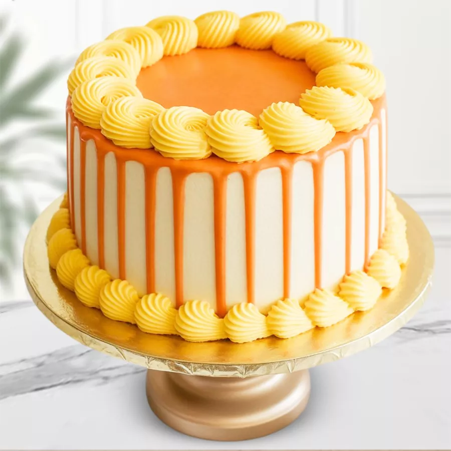 Eggless Butterscotch cake with cream frosting and sweet gel, decorated with fresh cream flowers.