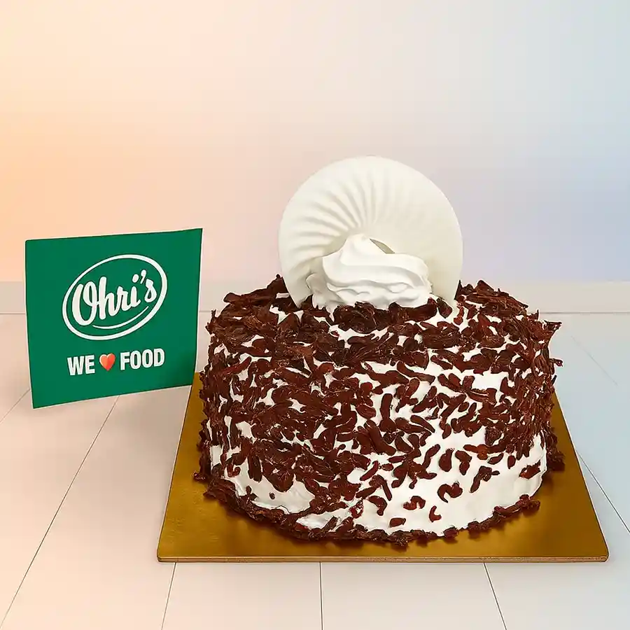 Choco Black Forest Cake featuring chocolate shavings and cherries.