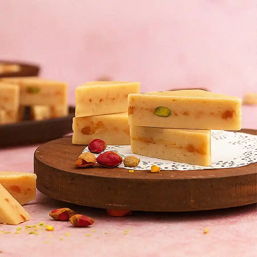 A beautifully arranged selection of Haldiram's Kaju Pista Sandwich sweets, perfect for celebrating Mother's Day.